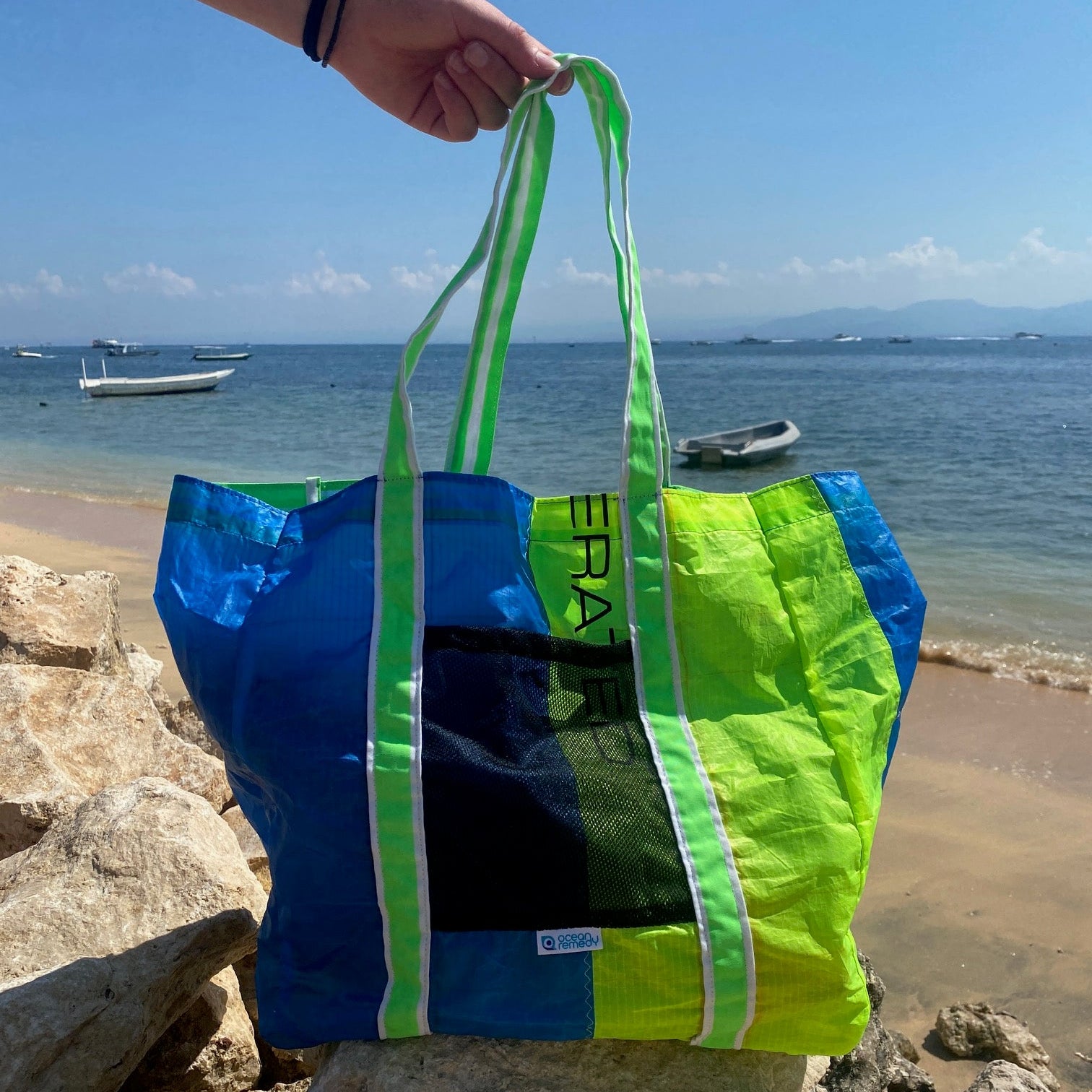 A bright lime green and blue upcycled tote bag made from a kite surfing kite - super strong, binding on the seams, mesh pocket on the outside. 